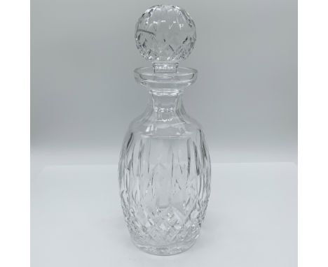 Elegant Waterford crystal decanter featuring a classic oval shape with diamond and vertical cut patterns. Complete with a fac