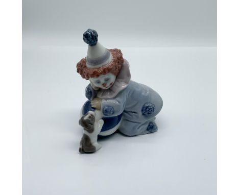 Lladro porcelain figurine titled Pierrot with Puppy and Ball, sculpted by José Puche. This charming piece features a playful 