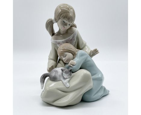 This elegant Lladro porcelain figurine, titled "Little Sister," was designed by sculptor Francisco Catalá and introduced in 1