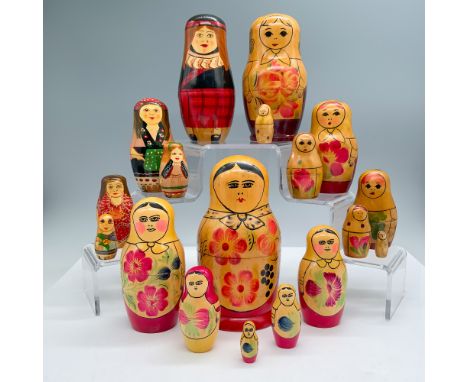 A collection of three vintage Russian nesting doll sets, each featuring vibrant hand-painted floral and traditional designs. 