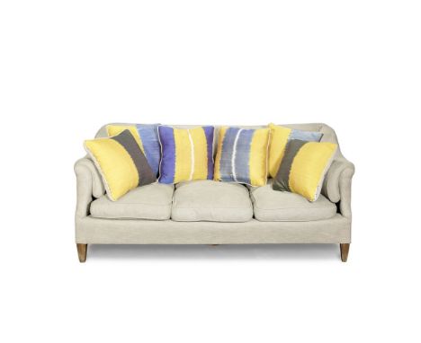 A HOWARD &amp; SONS 'BECKETT MODEL' SOFAUpholstered in grey fabric and together with a set of six ikat cushions, the back lef