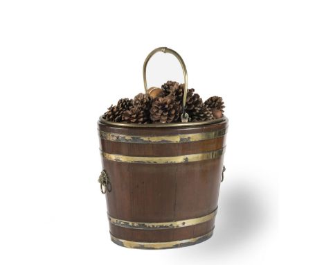 A GEORGE III MAHOGANY AND BRASS BOUND OVAL PEAT BUCKETWith lion mask ring handles, swing handle and brass liner, 40cm wide x 