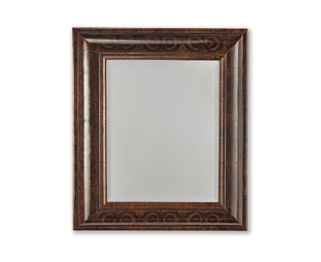 A WILLIAM AND MARY STYLE OLIVEWOOD CUSHION FRAMED MIRRORWith bevel edged glass plate,  75cm high x 65.5cm wide (29in high x 2