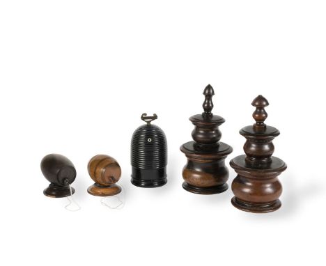 A NEAR PAIR OF LIGNUM VITAE COFFEE GRINDERSEarly 19th centuryEach with screw top surmounted by a turned tall finial with turn
