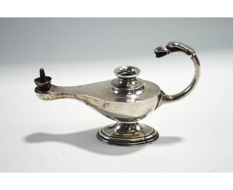 A loaded silver table lighter in the form of a Middle Eastern lamp, 15 cm long, lacking taper