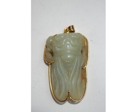 A Chinese jade carving of a cicada, within an unmarked gold mount, 6cm long