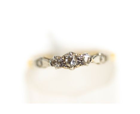 A three stone diamond 18 carat gold ring, finger size K, 1.4 g gross