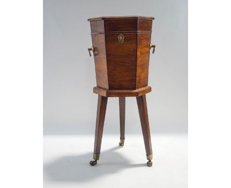 A George III style mahogany hexagonal wine cooler, on tripod base with brass castors, 68cm high x 31cm wide x 27cm deep