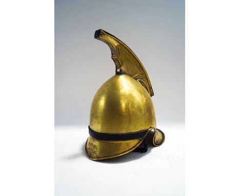 A brass fireman's helmet with replacement strap, 35cm high