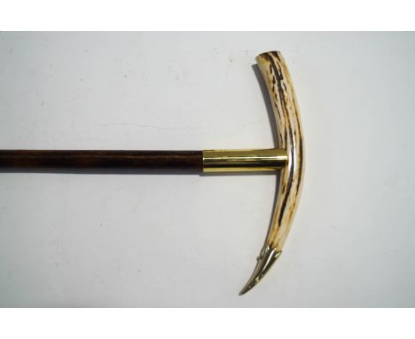 A bamboo shafted walking stick with Ibex horn handle and brass mounts