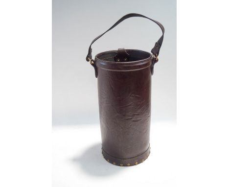  A cylindrical leather stick stand, with swing handle, 41cm high, 21cm diameter