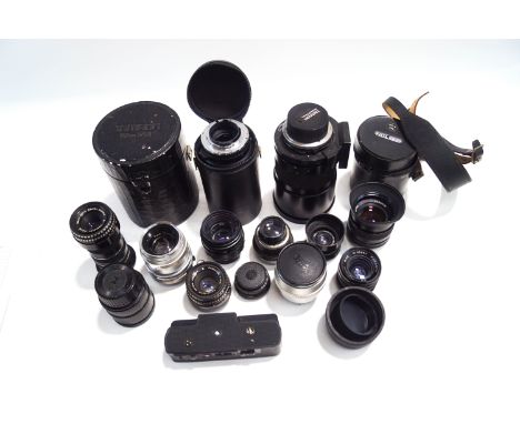 A collection of thirteen SLR camera lenses, cases and accessories, including Zeiss, Ikon, Paragon, Sigma, Russian examples