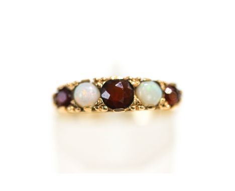 A 9 carat gold opal and garnet ring, finger size K1/2, 2.2 g gross