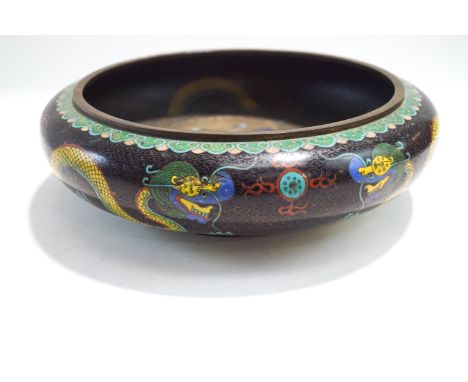 A Chinese cloisonne bowl, decorated with dragons, the interior dragon chasing a flaming pearl, 30cm diameter