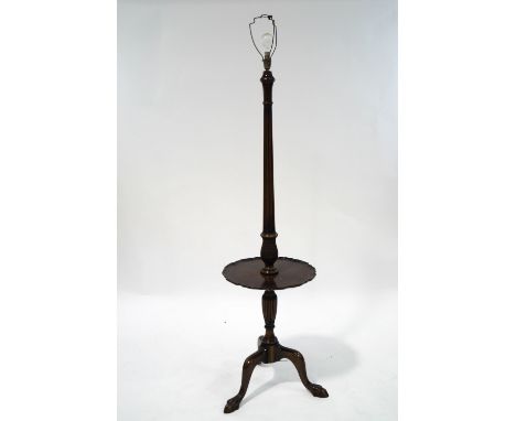 A mahogany standard lamp with circular shelf on cabriole legs and ball and claw feet, 166cm high