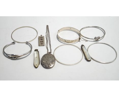 A collection of silver jewellery, including a diamond set torque bangle; an ingot pendant; and two folding fruit knives
