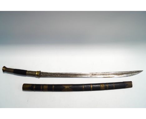 A Middle Eastern sword in bamboo scabbard with embossed metal mounts, the engraved blade 60cm long