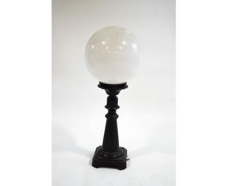 A patinated aluminium table lamp base with globular glass shade, 76cm high overall