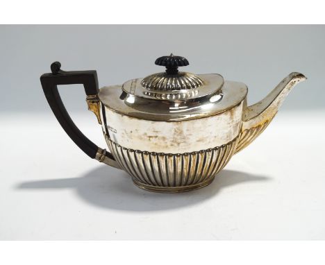 A silver teapot, by Martin & Hall, Sheffield 1903, of oval gadrooned form, 28 cm long, 724 g (23.3 troy ozs) gross