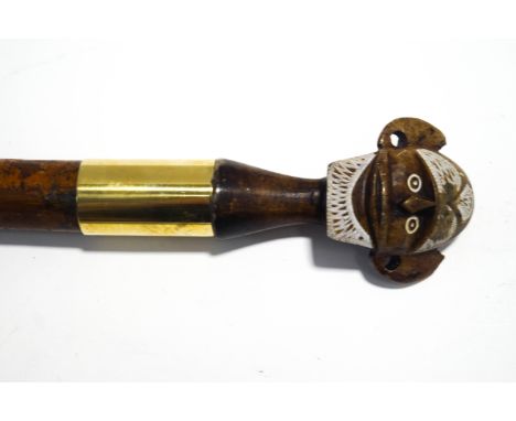 A Malacca shafted walking stick with carved tribal head knop