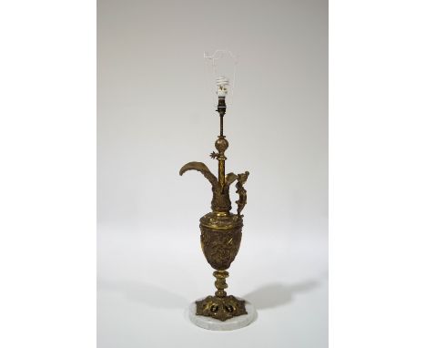 A decorative brass table lamp in the form of a Classical urn, on a circular white marble base, 83cm high