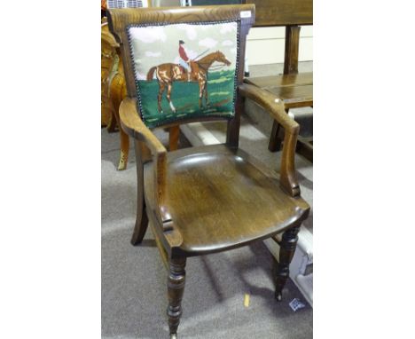 A Victorian oak desk elbow chair, with tapestry upholstered back