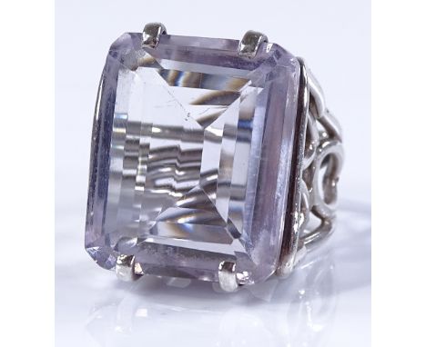 A large naturalistic amethyst and silver ring, with open work shoulders and shank, setting height 24.4mm, size M, 17g