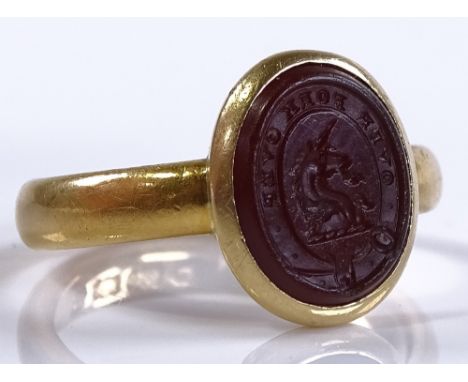 An Antique 22ct gold carnelian seal ring, with unicorn emblem and "over fork over" motto, setting height 13.4mm, size M, 7.1g