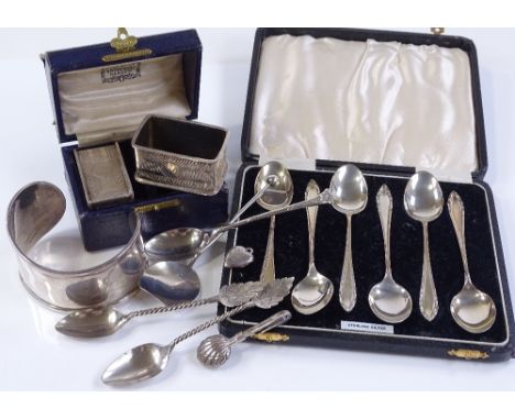 Silver teaspoons, a cased silver napkin ring, an unmarked white metal bangle etc