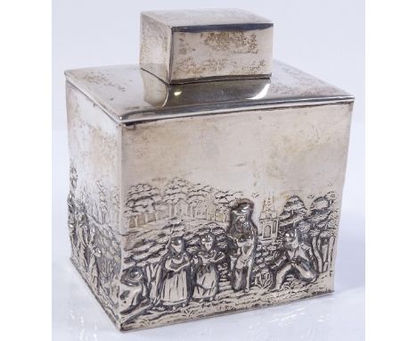 An embossed silver tea caddy, with country scenes by George Nathan and Ridley Hayes, hallmarks Chester 1911, height 8.5cm, 3.