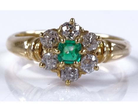 An unmarked gold emerald and diamond cluster dress ring, setting height 10.5mm, size P, 5.3g