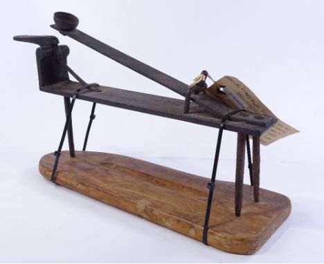 A Vintage Yorkshire miners clay ball launcher used in the game of Knur and Spell, or Miners Golf, wrought-iron on wooden base