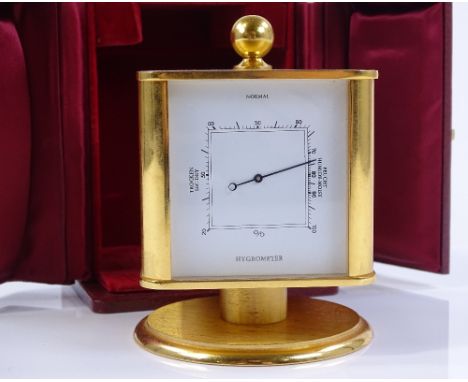 A Swiss made brass-cased combination desktop clock / thermometer / barometer / hygrometer, case height 9.5cm, original leathe