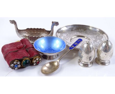 A circular silver dish with engraved dragon design, a silver and blue enamel spoon and bowl, a silver Viking boat etc (7)