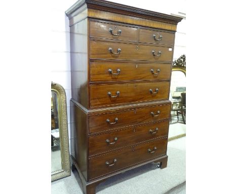 A George III mahogany chest on chest, carved and inlaid pediment with brass drop handles and bracket feet, width 3'6", height