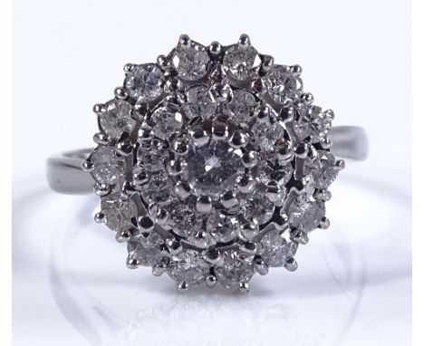 An 18ct white gold diamond cluster ring, central diamond approx 0.13cts, setting height 15mm, size Q, 5.5g