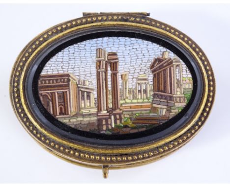 A 19th century Italian oval gilt-metal box, with pietra dura lid depicting Roman ruins, and champleve enamel decorated sides,