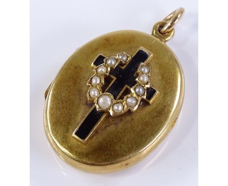 A Victorian unmarked gold pearl and enamel mourning locket, front set with black enamel cross and graduated pearl wreath, wit