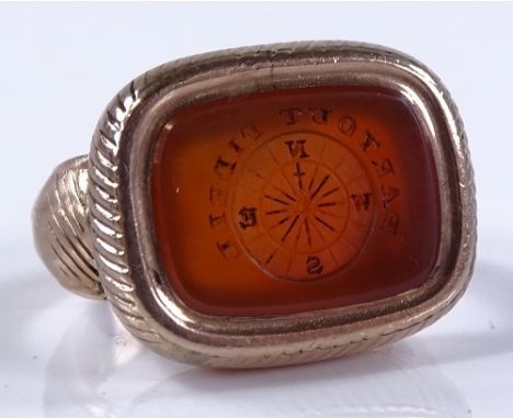 An unmarked gold carnelian intaglio seal ring, with compass emblem and "Partout Fidele" motto, setting height 14.9mm, size J,