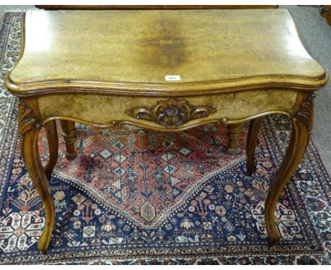 A Victorian walnut serpentine front fold over card table, with carved frieze and cabriole legs, width 2'9"