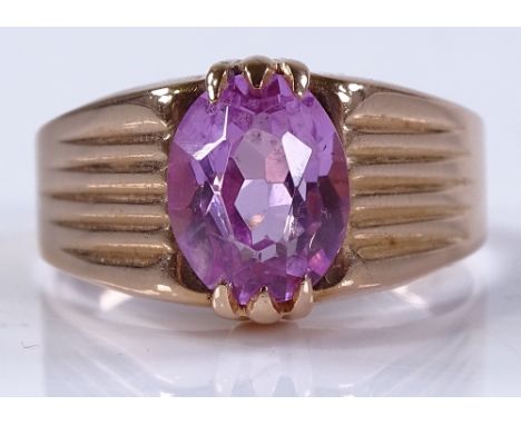 A 14ct gold pink stone gypsy ring, possibly a pink sapphire, setting height 11.8mm, size S, 5.2g, marks on shank