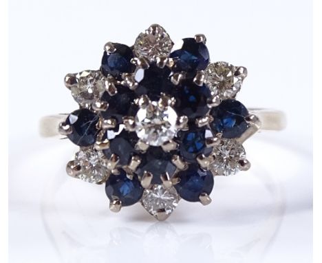 An 18ct gold diamond and sapphire cluster ring, setting height 13.6mm, size M, hallmarks Birmingham 1954, 4g