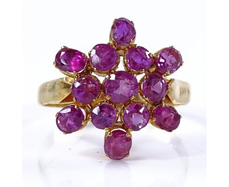 An unmarked gold ruby cluster ring, setting height 16mm, size O, 3.2g