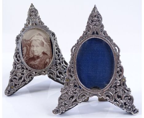 A pair of silver fronted arrow shaped photo frames, with embossed and pierced scroll and floral decoration, by Rosenthal, Jac