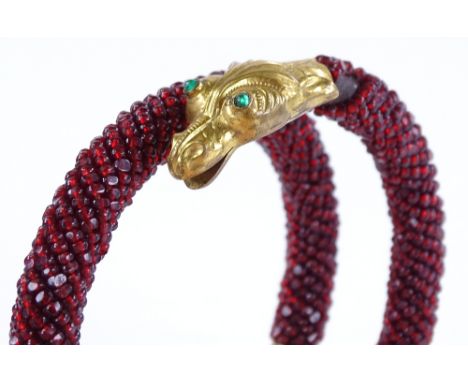 A large garnet set serpent bangle, pinchbeck head and tail, internal diameter 77mm
