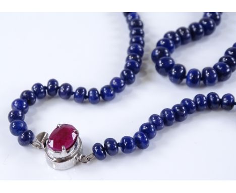 A long bead-cut sapphire necklace, with ruby set silver clasp, length 740mm, 81.7g