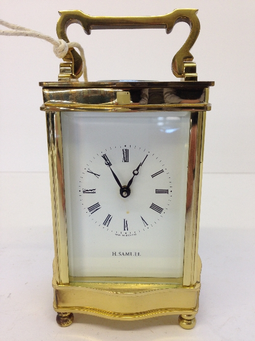 A brass and glass cased H Samuel carriage clock.