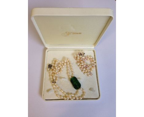 A double strand of Fresh Water pearls with green Jade mount and silver clasp together with a Fresh Water pearl necklace.