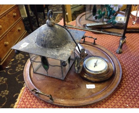 An early 20th century leaded glass porch lantern together with an Art Deco circular oak tray and wall barometer.
