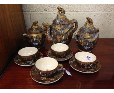 The residue of an early 20th century Satsuma tea service comprising teapot, milk jug and sugar basin and cover together with 